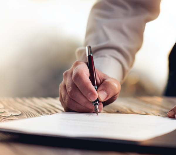 person signing paper