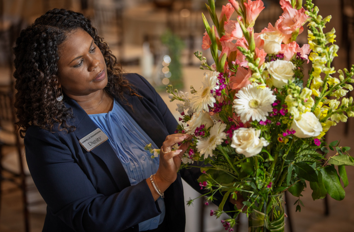A funeral director decorates a Memory Table